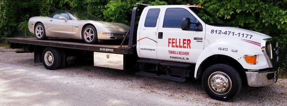 car on flatbed tow truck